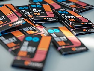 Multiple colorful board game cards with orange, pink, and blue designs arranged on a surface