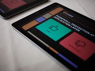 Smartphone displaying firewall protection application layer interface with colorful tiles and security icons